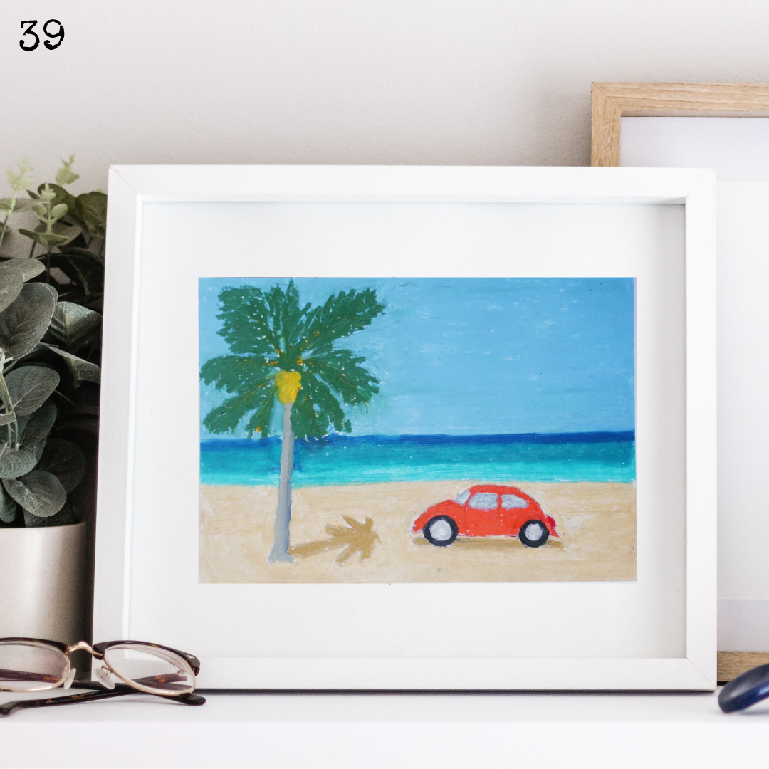 A white framed oil pastel painting of a vintage car on the beach under a coconut tree