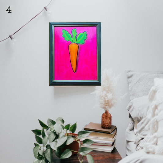 An oil painting of an orange carrot on a pink background in a thrifted frame in a boho decor