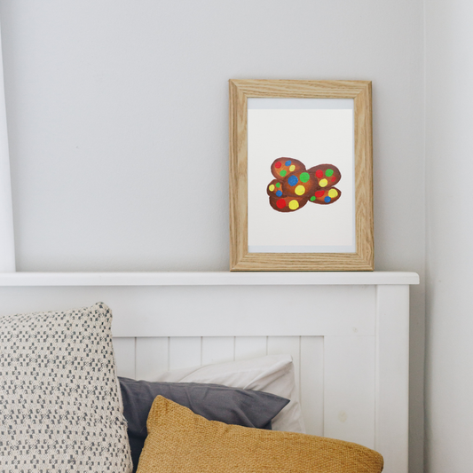 A framed painting of chocolate cookies with colourful M&Ms