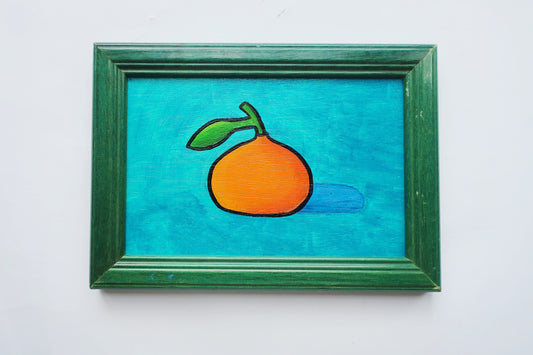 An oil painting of an orange clementine on a turquoise background in a vintage frame