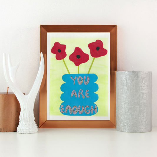 A brown framed collage of three red poppies in a blue vase with the words you are enough