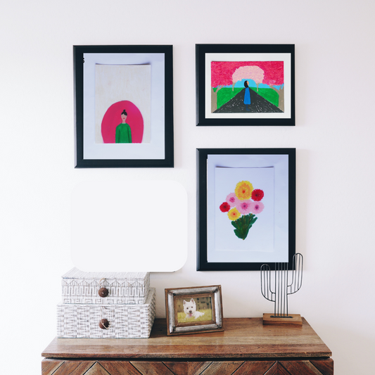 Three black framed pink oil pastel paintings in a boho decor