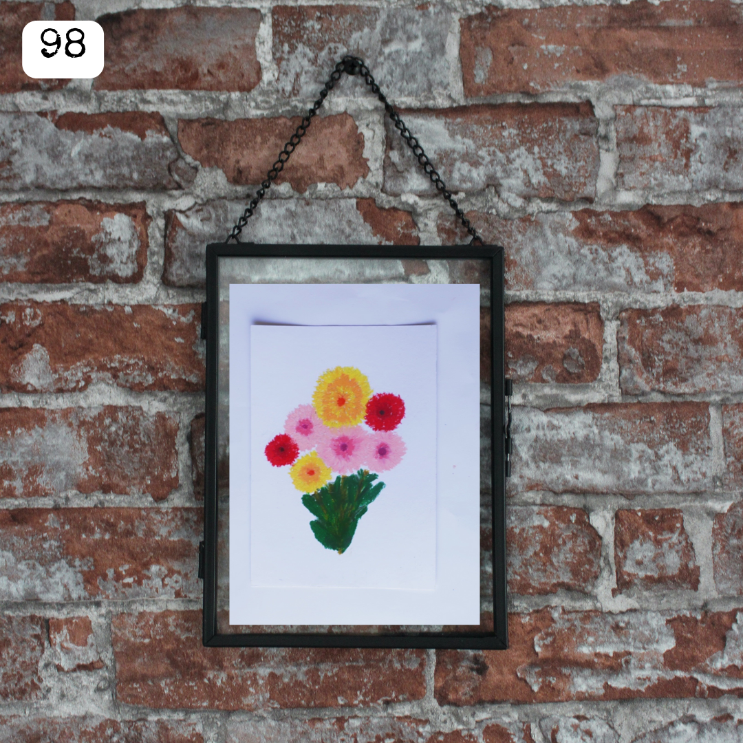 A black framed oil pastel painting of a colourful flower bouquet
