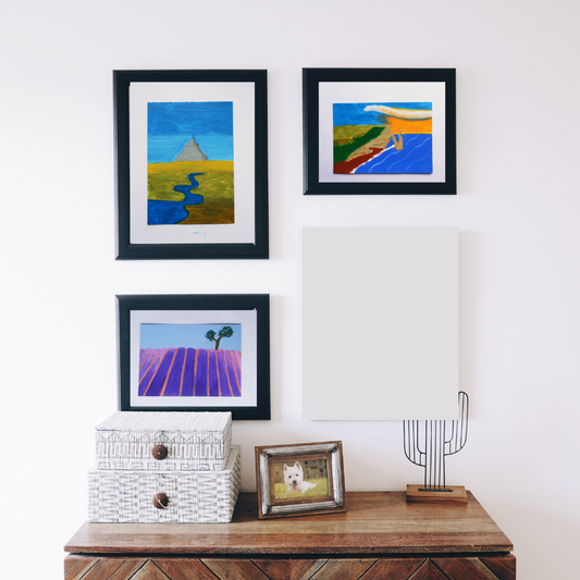 Three black framed paintings of French scenes in a boho decor