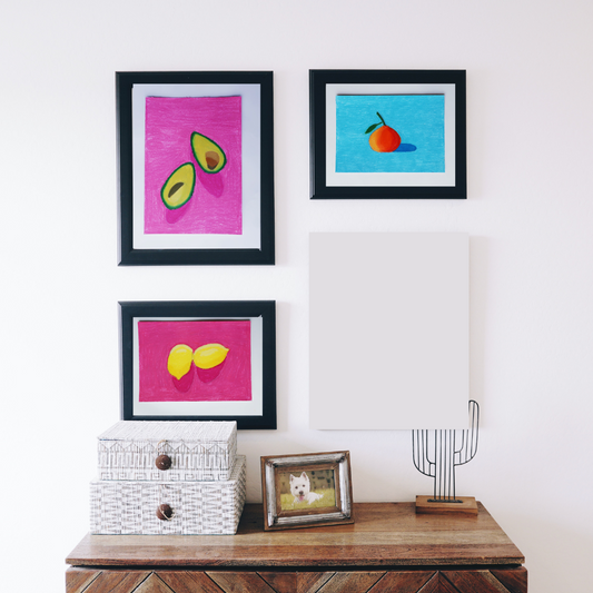 Three black framed paintings of fruits in a boho decor