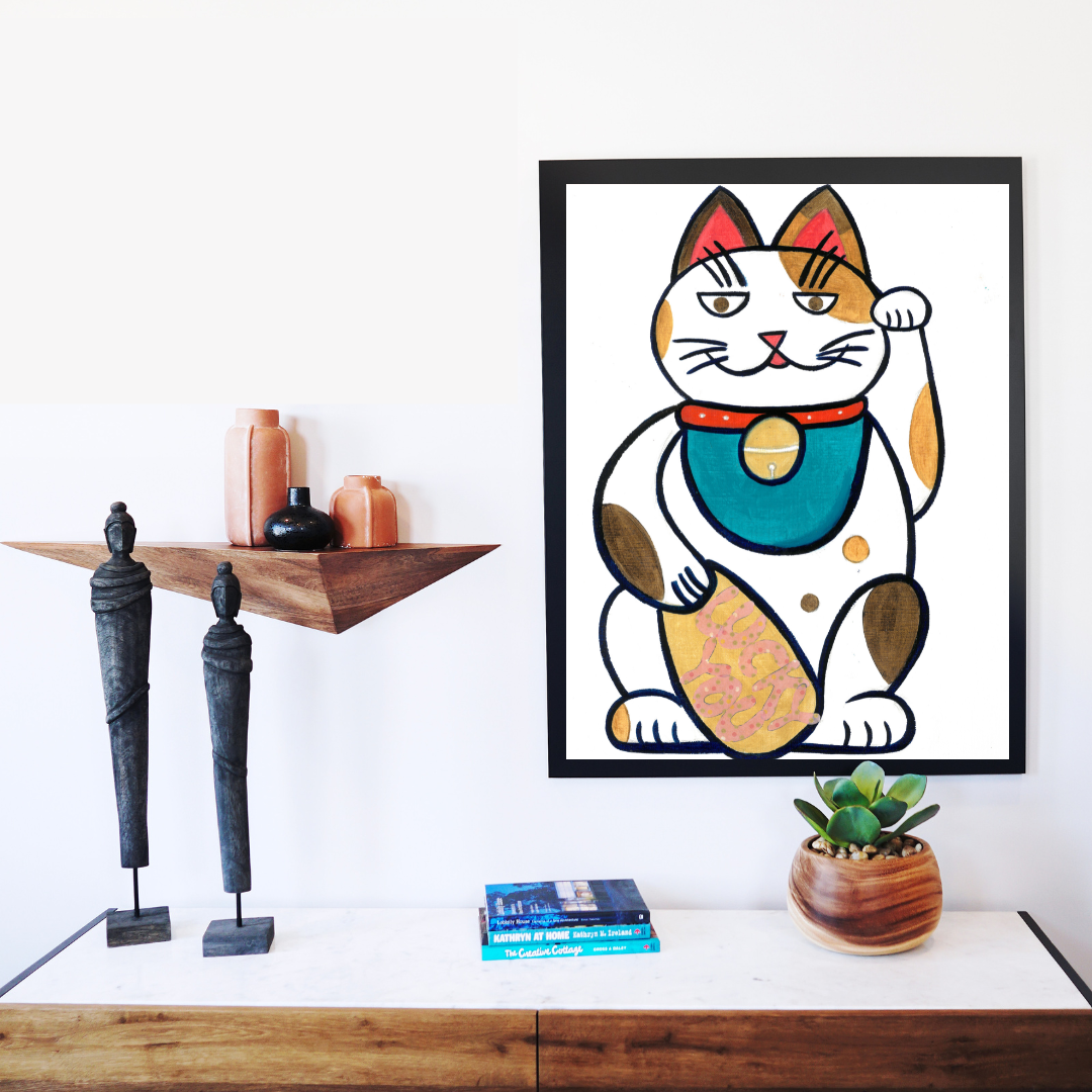 A black framed print of an oil painting of a tri-colored lucky cat holding a golden coin with the words lucky you in a boho decor