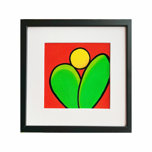 A black framed oil painting of two green leaves under a rising sun on a red background