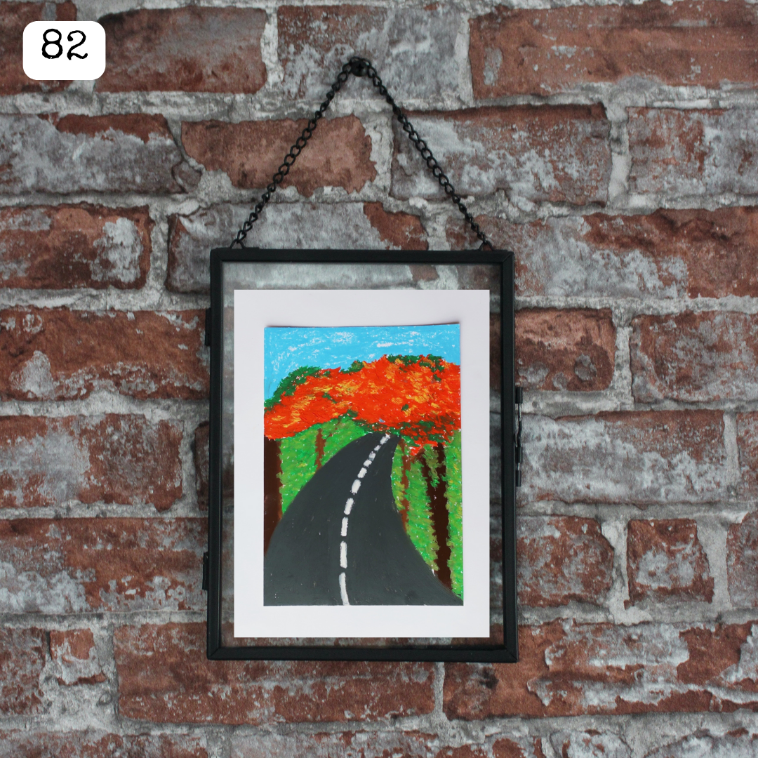 A black framed oil pastel painting of a black road with red flame trees