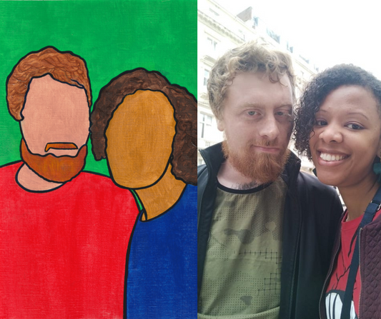 A faceless oil portrait of a red-bearded man and a black girl on an easel with a photo of the couple