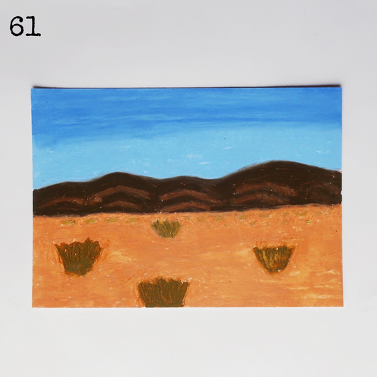 An oil pastel painting of a desert scene with the mountain under a blue sky