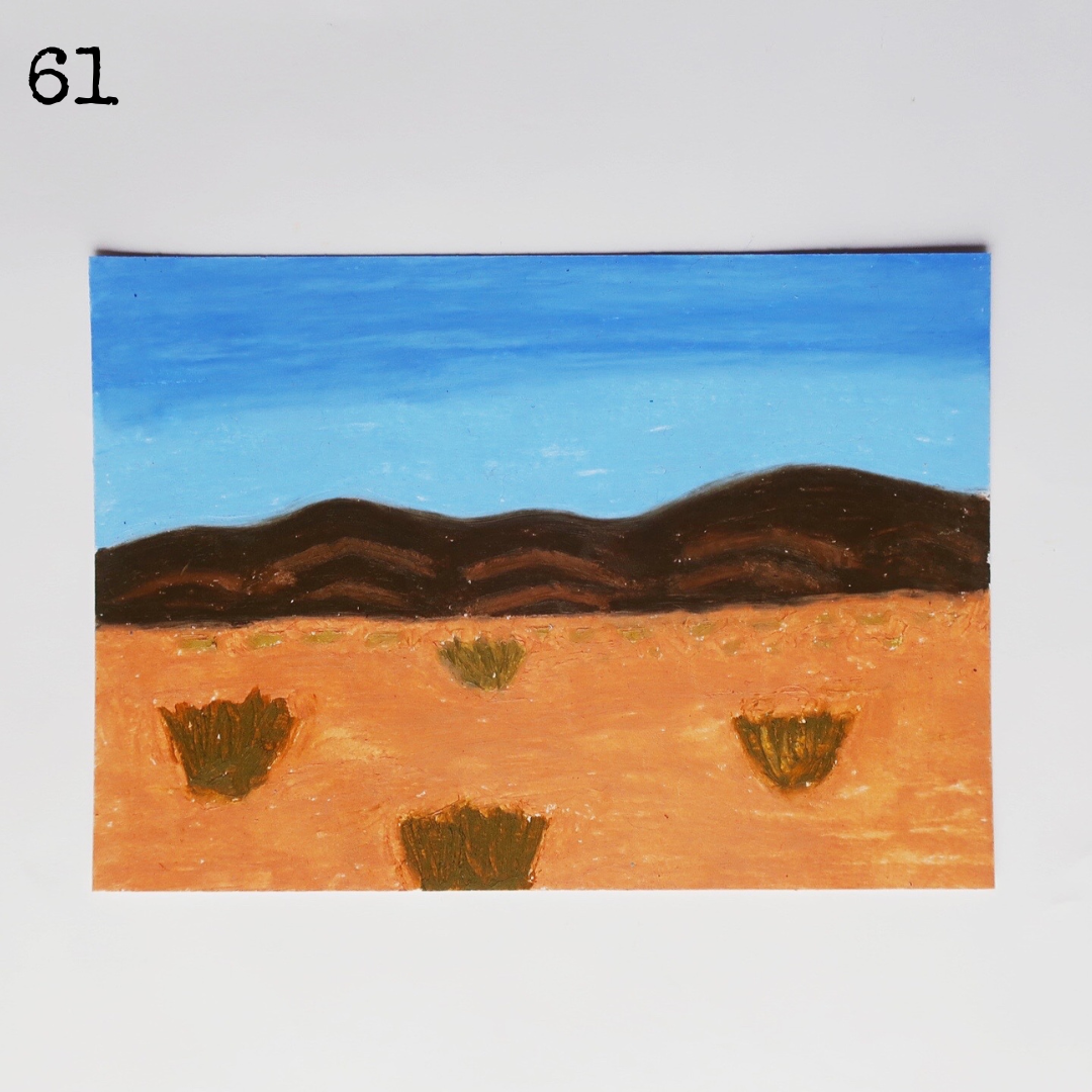 An  oil pastel painting of a desert scene with the mountain under a blue sky