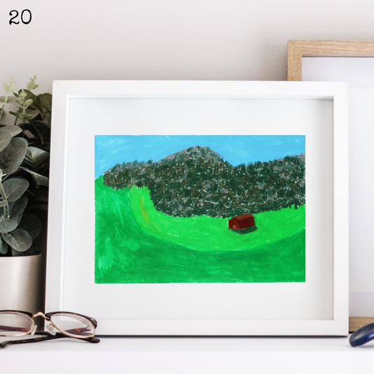 A white framed oil pastel painting of a cute wooden house in a mountain valley