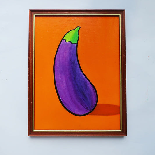 An oil painting of a purple eggplant on an orange background in a thrifted frame