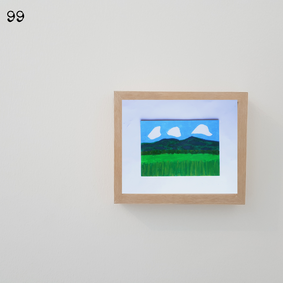 A wooden framed oil pastel painting of a green field under the blue sky