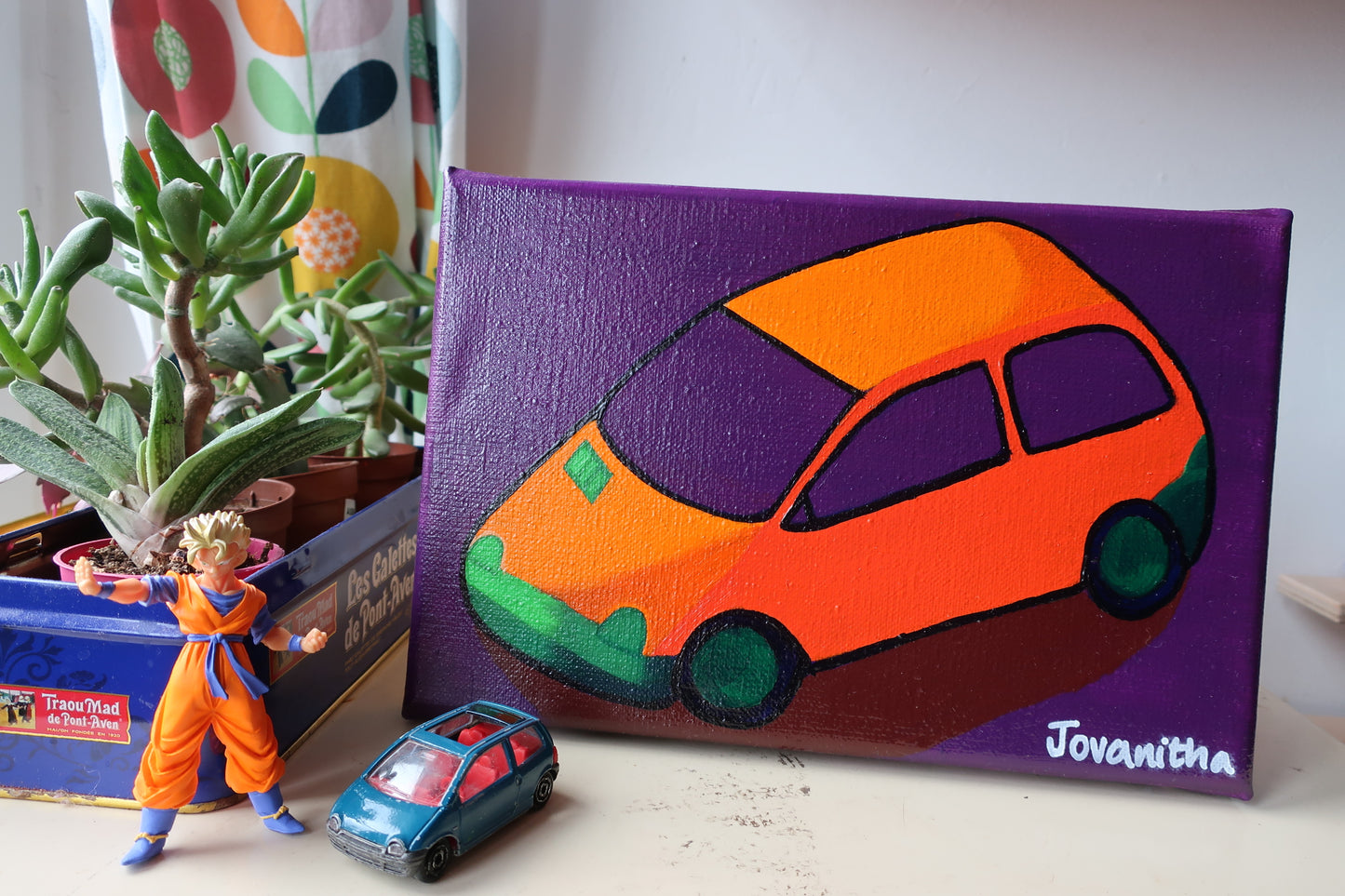 An oil painting of an orange Renault twingo car against a violet background on a white shelf