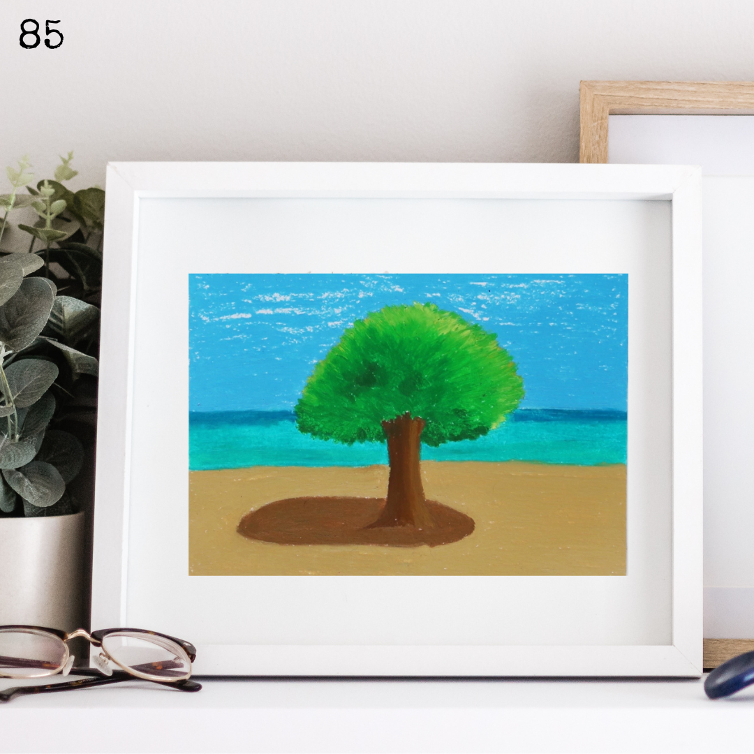 A white framed oil pastel painting of a tree on the beach